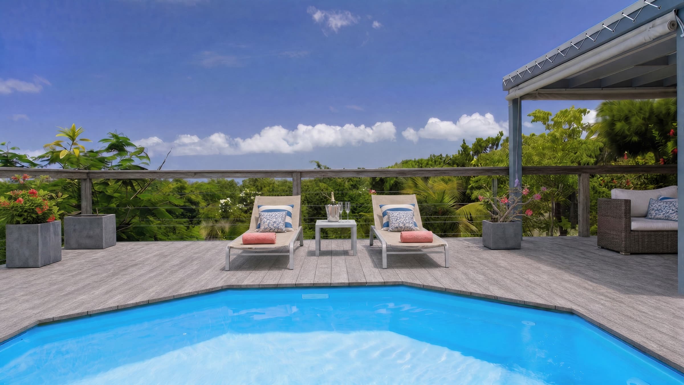 Private plunge pool and twin loungers with coral towels overlooking the treetops