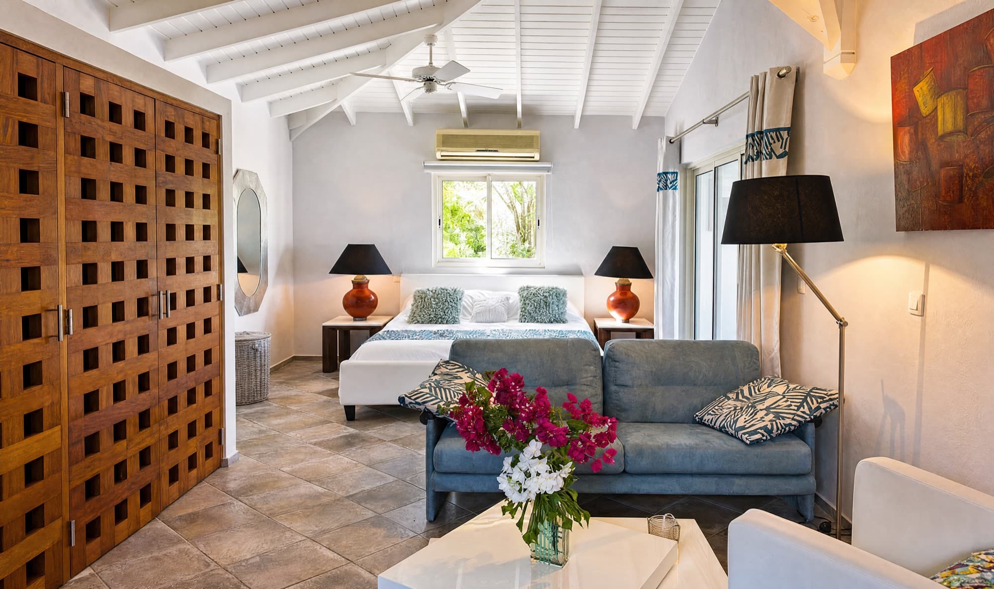 King bedroom suite with designer linens and vaulted ceiling